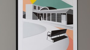 A framed architectural drawing of a modern building with a curved facade, a central entrance, and a bench in the foreground.