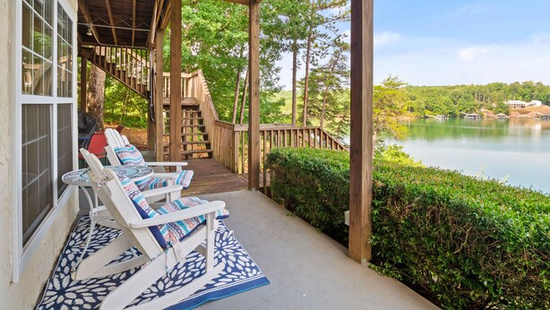 A wooden deck with lounge chairs and a staircase leading to a covered area. - Blue Door - Entertainment area downstairs with a pool table (Arley)