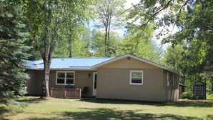 A single-story house with a fenced yard, a small porch, and a shed. - Book your SUMMER FUN now - lakes, waterfalls, ATV/UTV trails! Your fun awaits! (Crivitz)