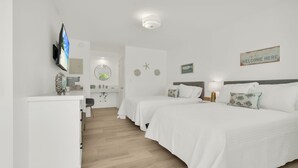 A hotel room with two beds, a desk, a TV, and a "Welcome Here" sign. - Boutique Hotel 2 double beds with POOL, LOCATION! 1 block to BEACH/Restaurants (Deerfield Beach)