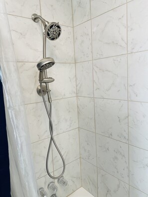 Combined shower/tub, hair dryer, towels, toilet paper
