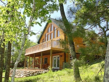 Log chalet with a wall of windows overlooking Minong Flowage