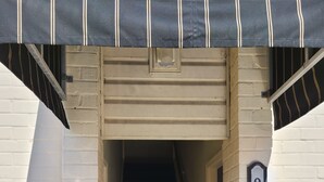 A narrow stairway leading to a door with a number plate '915'.