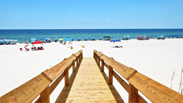 A wooden boardwalk leading to a beach with white sand and clear blue water. - Hammock Dunes J (Orange Beach)