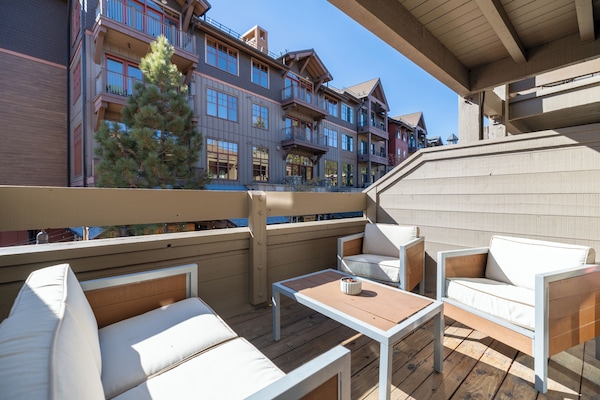 Sunny balcony with seating.