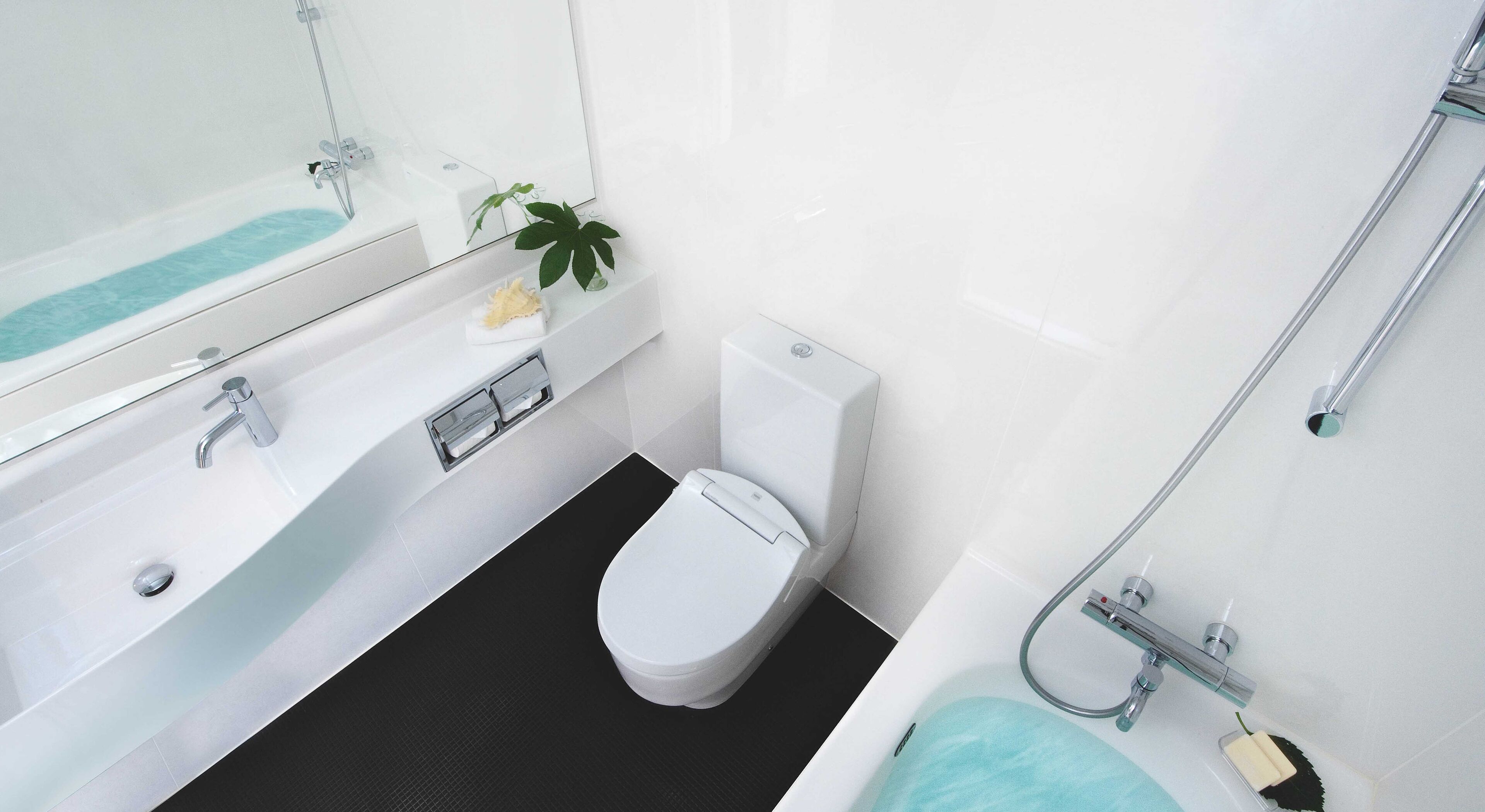 A modern bathroom with a bathtub, toilet, and sink.