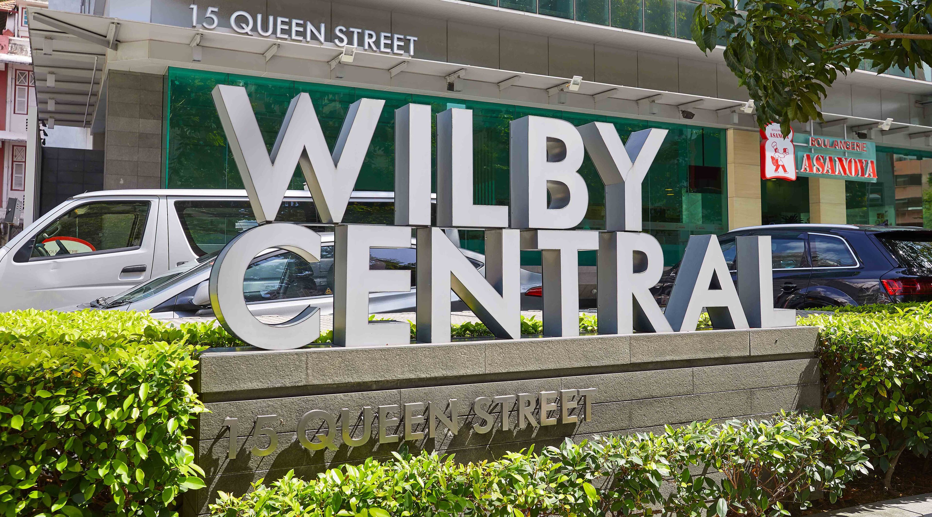 A sign for 'WILBY CENTRAL' with '15 QUEEN STREET' below it.