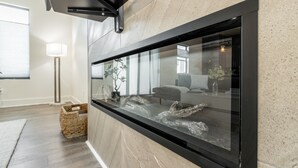 A modern kitchen with a large window, a built-in oven, and a wicker basket on the floor. - Brand new Bishop Arts Condo-Right in the middle of it all! Three bathrooms! (Dallas)