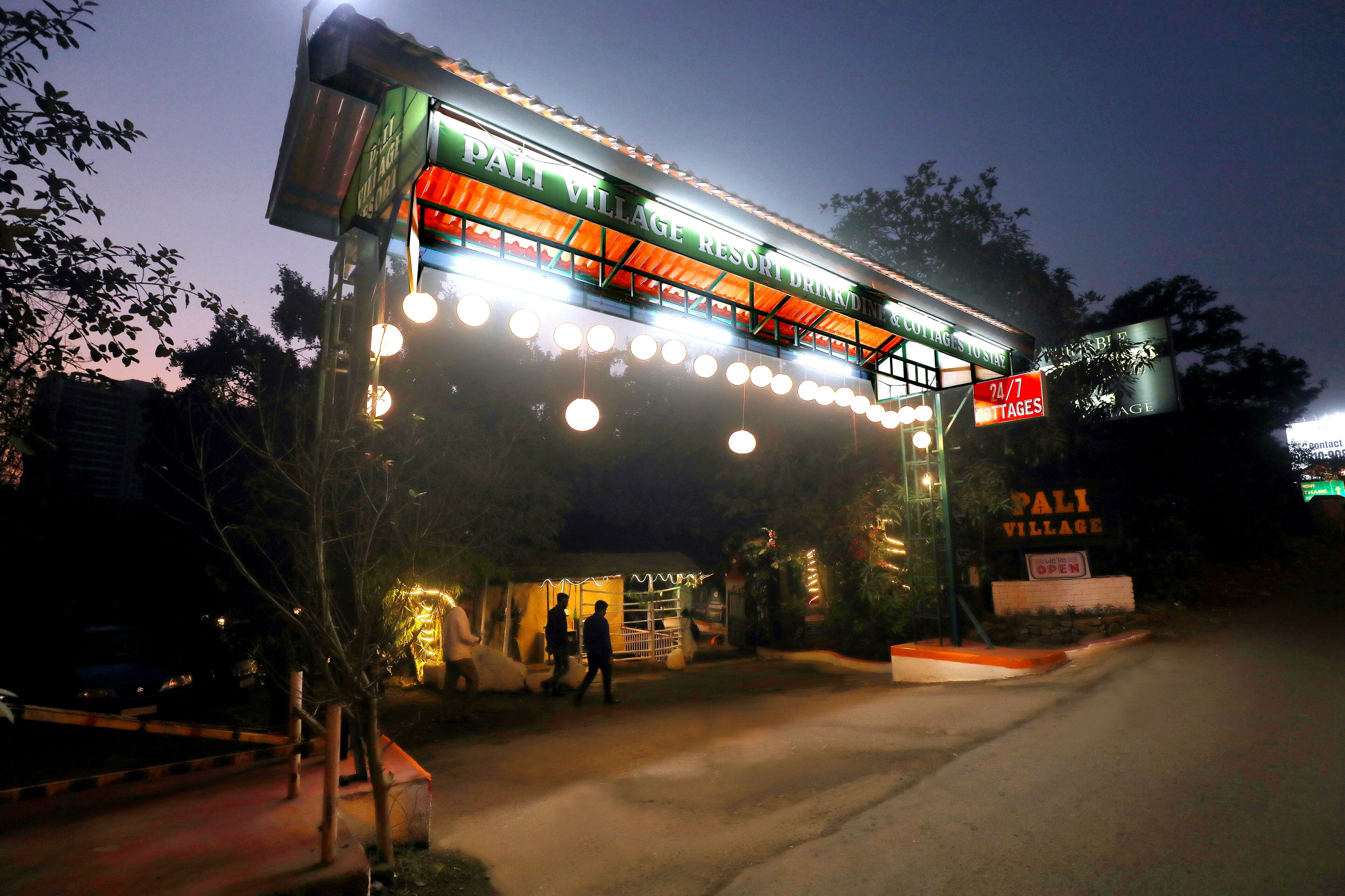 A resort entrance with a sign reading "Pali Village Resort".