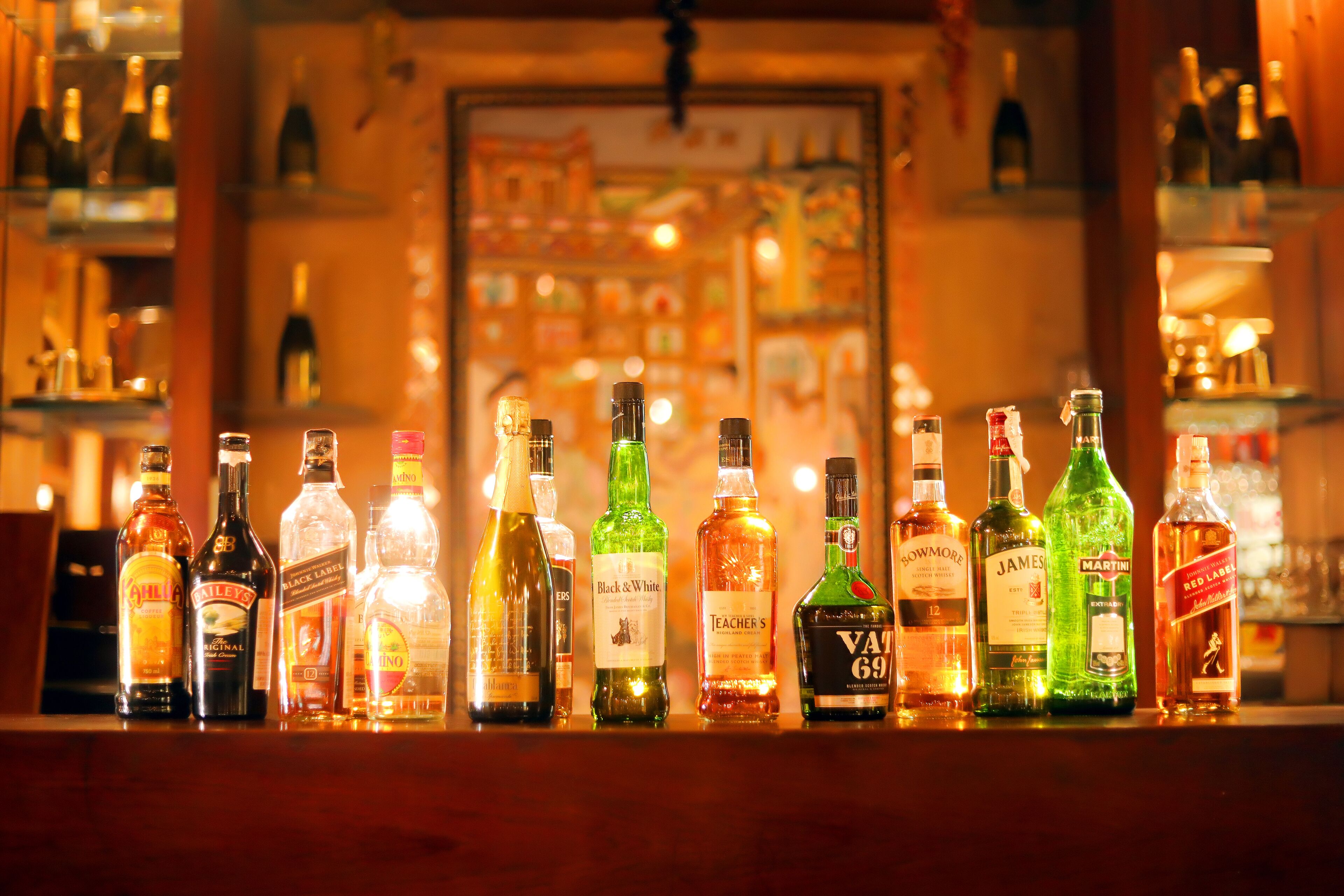 A bar with various liquor bottles displayed on shelves.