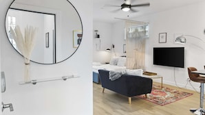 A modern living room with a sofa, TV, and ceiling fan. - Poolside studio with rooftop deck (Scottsdale)