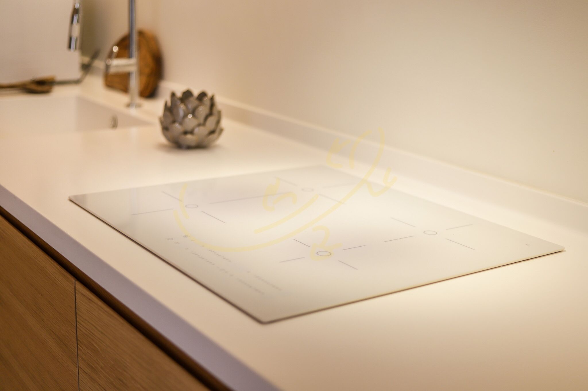 A white countertop with a decorative object and a piece of paper with a diagram.