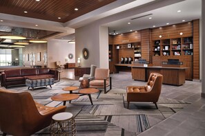 A modern lobby with leather sofas, a coffee bar, and a reception desk. - Four Points by Sheraton Yuma (Yuma)