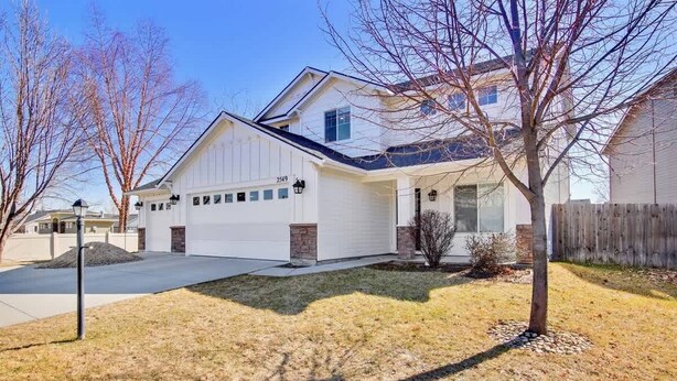 A single-story house with a garage, a front porch, and a small front yard.