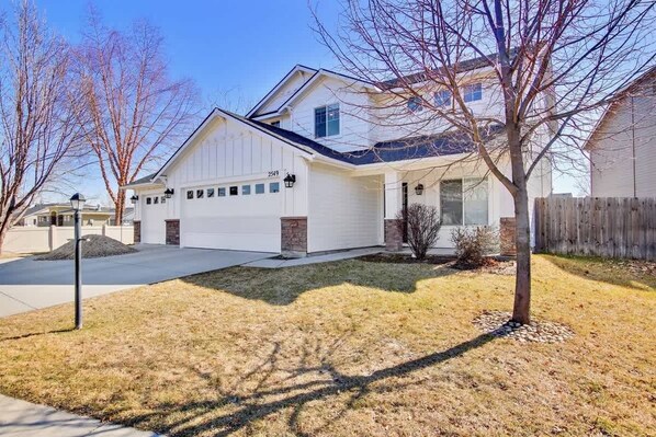 A single-story house with a garage, a front porch, and a small front yard.