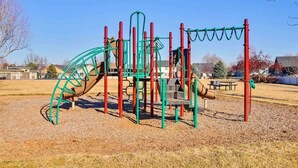 A playground with climbing structures and slides.