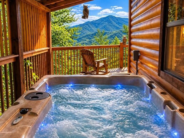 A hot tub with a wooden deck and a mountain view. - Cabin Of Many Colors, Hot Tub, Mtn Views, Cozy Cabin Retreat in the Smokies!!! (Sevierville)