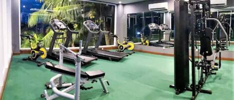 A gym with treadmills, stationary bikes, and weight machines.