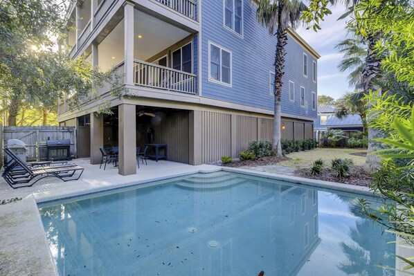 A two-story house with a pool, outdoor furniture, and a covered patio area. - Sunset Rentals | Four Thirty Third (Isle of Palms)