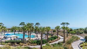 A resort with multiple swimming pools, palm trees, and a boardwalk. - Direct Oceanfront Villa / Heated Pool & Ocean View (Hilton Head Island)