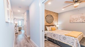 A bedroom with a bed, a ceiling fan, and a wall-mounted artwork. - Direct Oceanfront Villa / Heated Pool & Ocean View (Hilton Head Island)