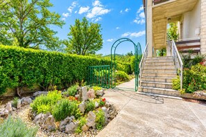 A landscaped garden with a stone pathway leading to a staircase.