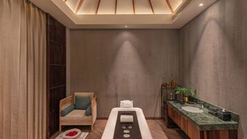 Relax in comfort with a long massage table and a convenient vanity area.