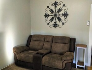 Relax in this stylish living room with a comfortable sofa, decorative wall art, and a side table.