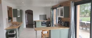 Enjoy meals in this kitchen with a central island, oven, microwave, and coffee machine.