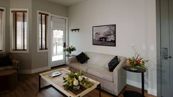 Suite, 1 King Bed with Sofa bed, Patio | Living area | Flat-screen TV