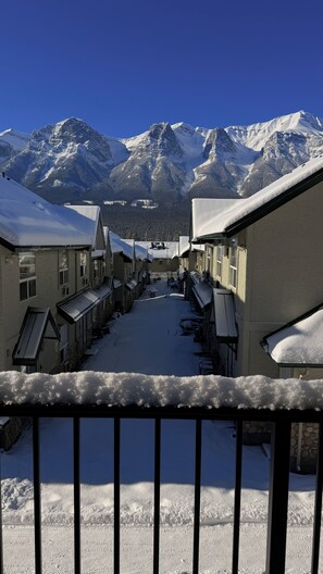 A snow-covered village with traditional buildings and a mountain backdrop.