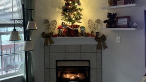 A living room with a fireplace, a Christmas tree, and holiday decorations. - Great Location! Close to Everything!
Game Room! Perfect for Family & Friends! (Pigeon Forge)
