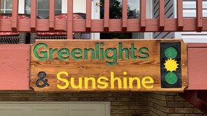 A wooden sign with the text "Greenlights & Sunshine" and a traffic light graphic. - Great Location! Close to Everything!
Game Room! Perfect for Family & Friends! (Pigeon Forge)