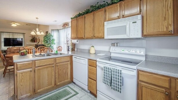 A kitchen with wooden cabinets, a microwave, a stove, and a dishwasher. - Great Location! Close to Everything!
Game Room! Perfect for Family & Friends! (Pigeon Forge)