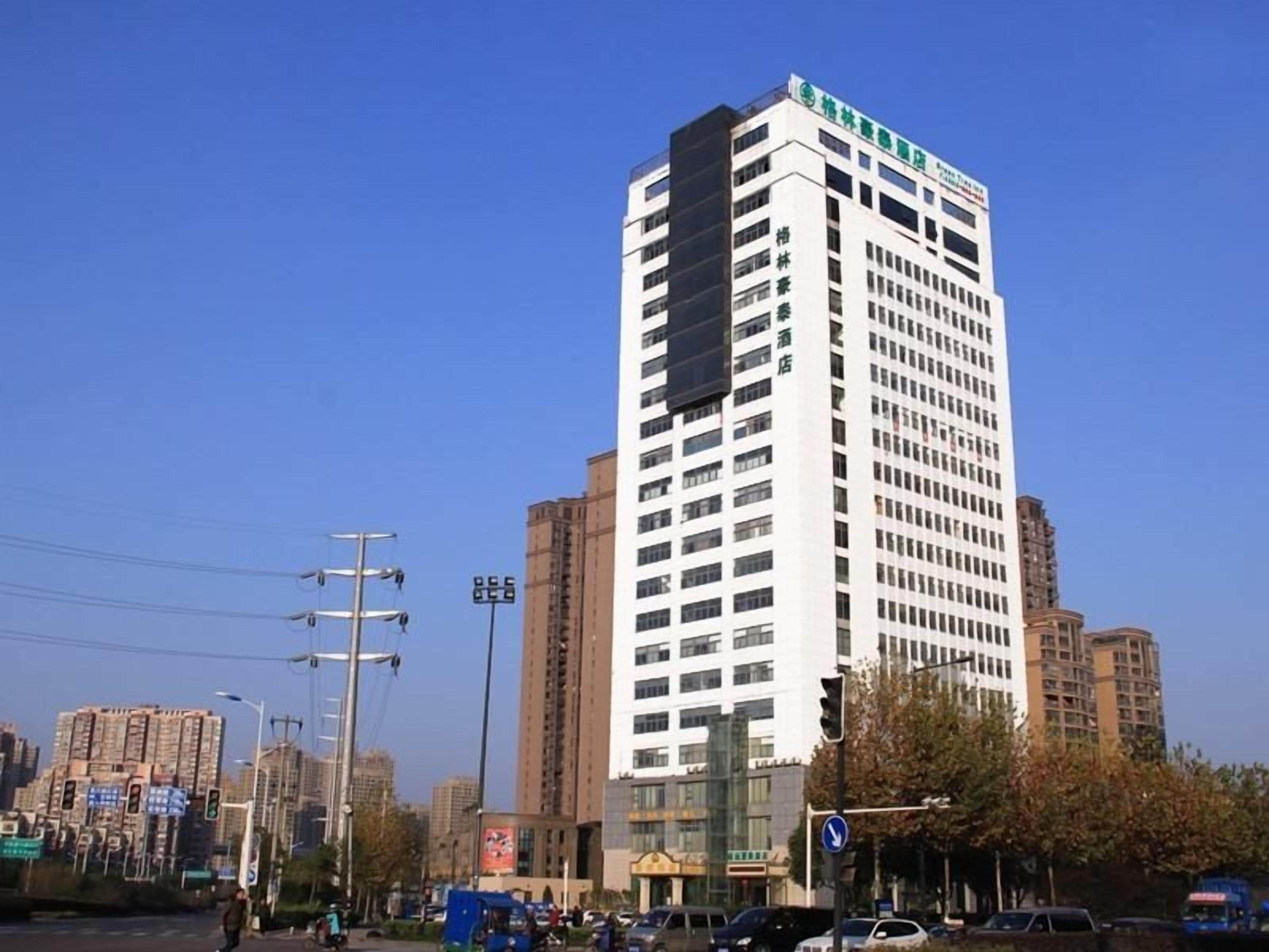 A tall, multi-story building with a flat facade and numerous windows.