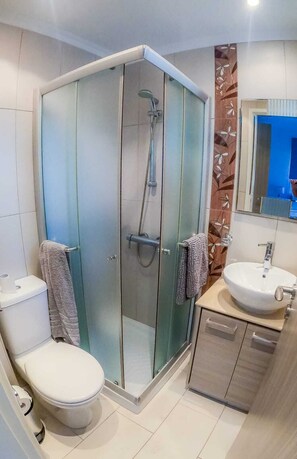 A modern bathroom with a glass-enclosed shower, a toilet, and a sink with a cabinet. - Villa Alba, Luxury 4 BDRM Villa with Heated Pool (Protaras)