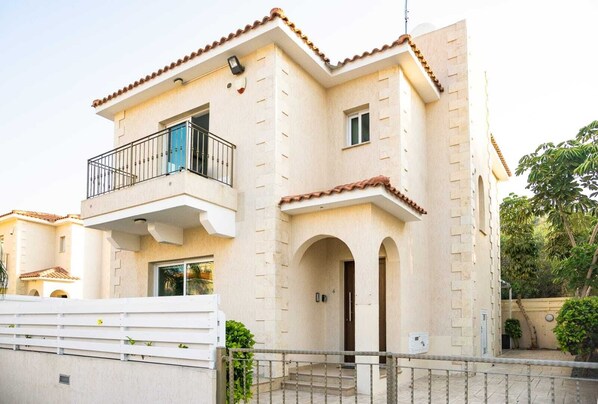 A two-story building with a balcony, a small window, and a door. - Villa Alba, Luxury 4 BDRM Villa with Heated Pool (Protaras)