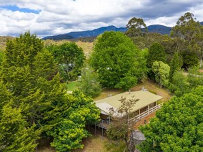 Surrounded by lush greenery, this single-story residence offers a serene view of the surrounding hills.