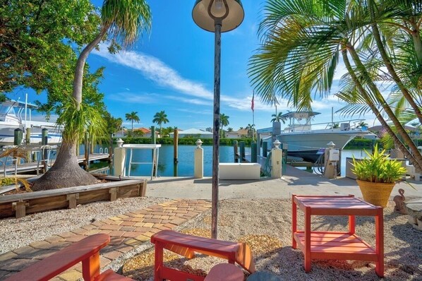 A marina with boats, a wooden bench, a table, and a lamp post. - P16 - Charming 2 bedroom 2 bath waterfront duplex with Cabana Club. (Key Colony Beach)