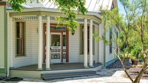 A building with a porch, columns, and a door labeled 'Jersey City.' - Morning Glory | Newly Renovated | Pet-friendly (Fredericksburg)