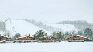A wooden lodge with a ski lift in the background.