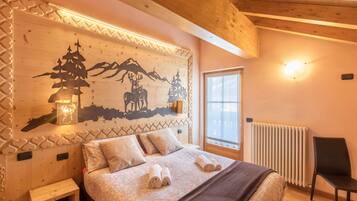 A wooden bedroom with a bed, pillows, a nightstand, a chair, a window, and a wall with a decorative design.