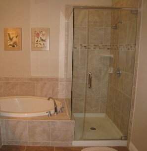 Separate tub and shower, towels, soap, shampoo