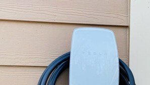 A Tesla charging station mounted on a wooden wall. - NEW! STUNNING Lake Harmony Mountain House Golfing! (Lake Harmony)