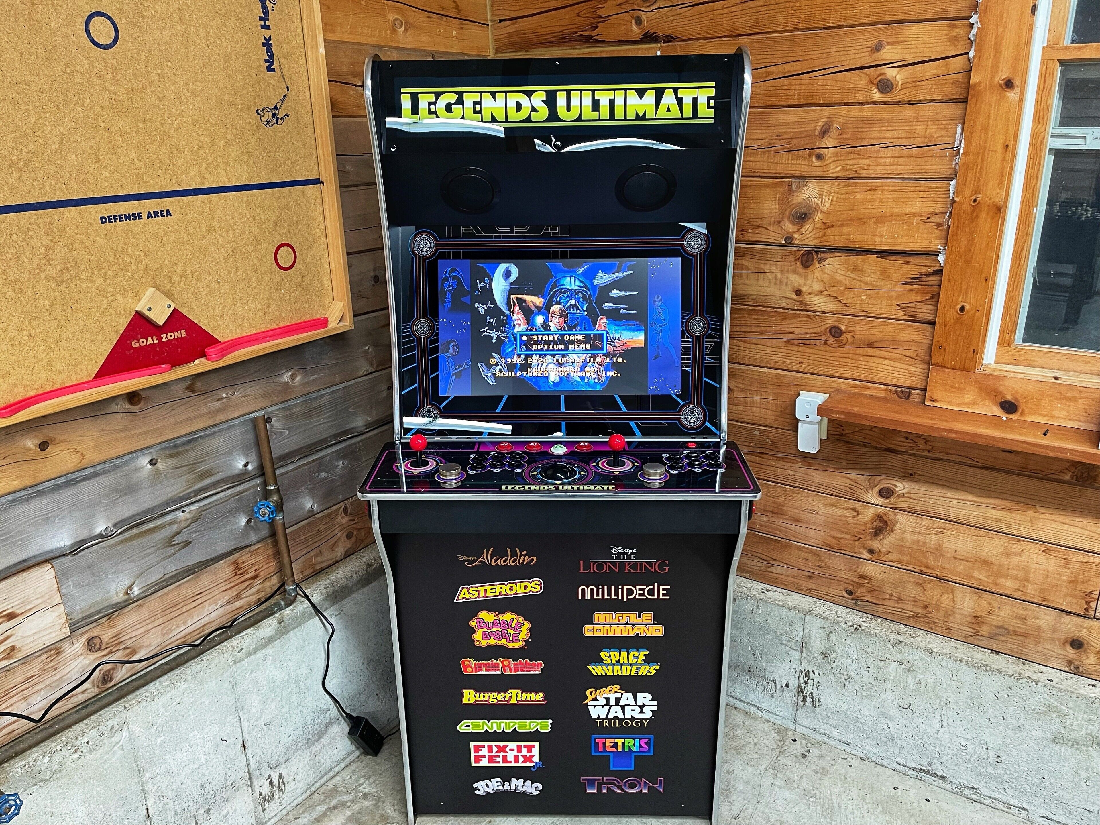 A pinball machine titled 'LEGENDS ULTIMATE' with a selection of game options visible on the front panel.