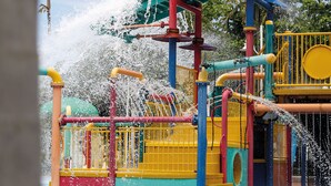 A water play area with multiple water jets and colorful structures. - Island View Motel (North Ward)