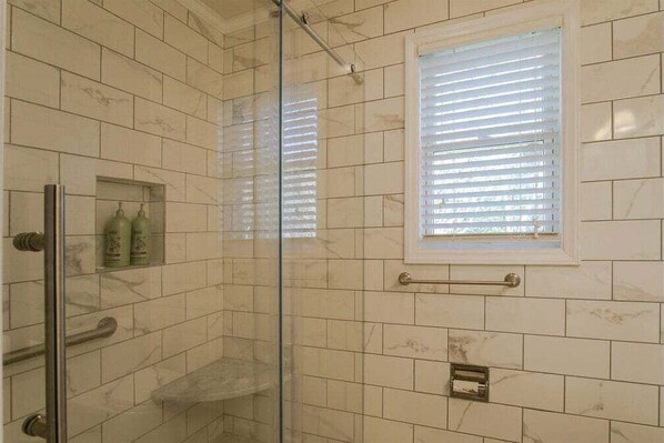 A bathroom with a glass shower enclosure, a small window with blinds, and a towel rack. - Sunshine Daydream in Pisgah Forest Area (Pisgah Forest)