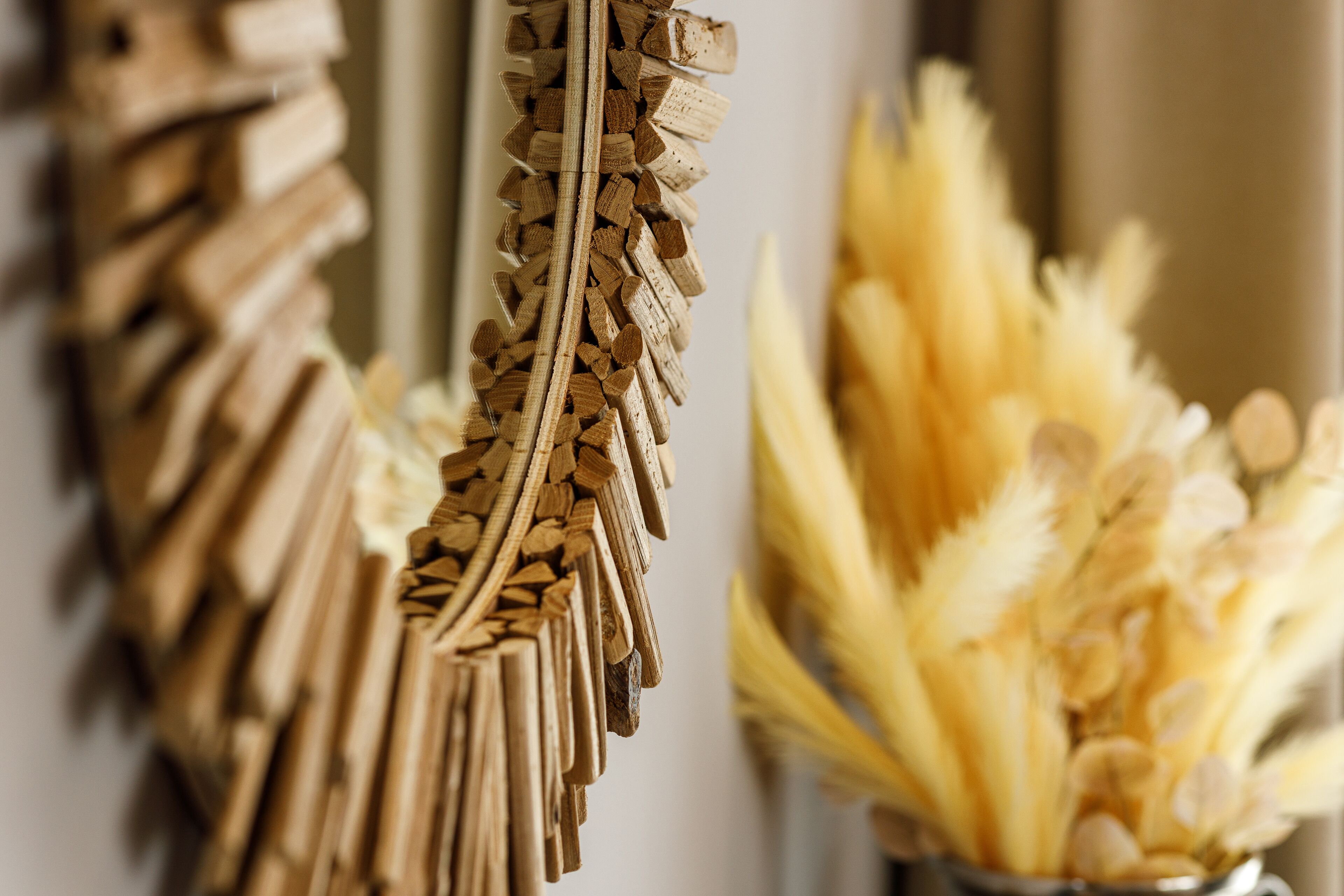 A decorative arrangement of wooden sticks and dried flowers.