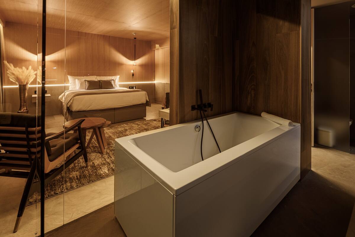 signature junior suite | bathroom | bathtub, free toiletries, hair dryer, bathrobes