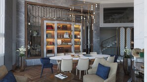 A spacious living area with a marble fireplace, a large bookshelf, and a dining table with chairs. - Orientbank Hotel Istanbul, Autograph Collection (Istanbul)